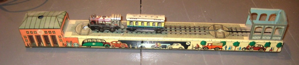 Vintage Arnold model train station. Includes both cars (one missing two wheels), wind-up key is also missing. Still in beautiful shape. 1940s $75