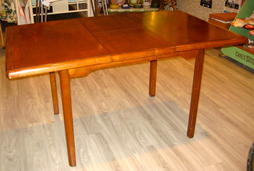 The full length of table with the leaf out.